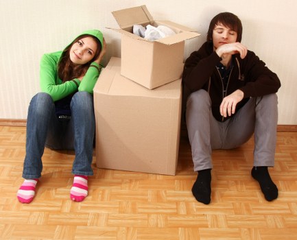 Movers carrying household items from a flat in Tooting