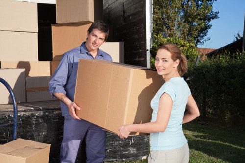 Movers carrying furniture in a Tooting flat